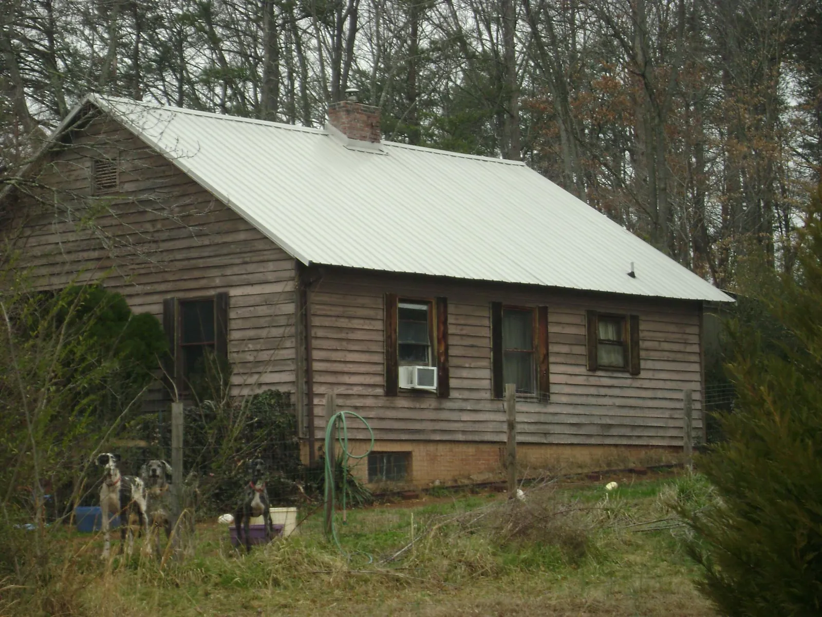 White metal roof on an old wood sided farmhouse, from a Metal Roof Installation job in Stamford